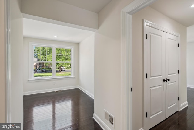 hall with baseboards, visible vents, dark wood-style flooring, and recessed lighting