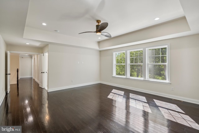 spare room featuring dark wood-style floors, visible vents, baseboards, and recessed lighting