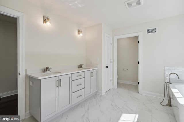 full bath featuring marble finish floor, a sink, visible vents, and baseboards