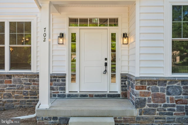 entrance to property featuring stone siding