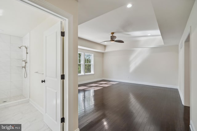 empty room with a ceiling fan, recessed lighting, wood-type flooring, and baseboards