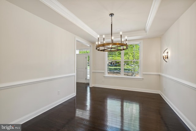 unfurnished dining area with wood-type flooring, a tray ceiling, baseboards, and ornamental molding