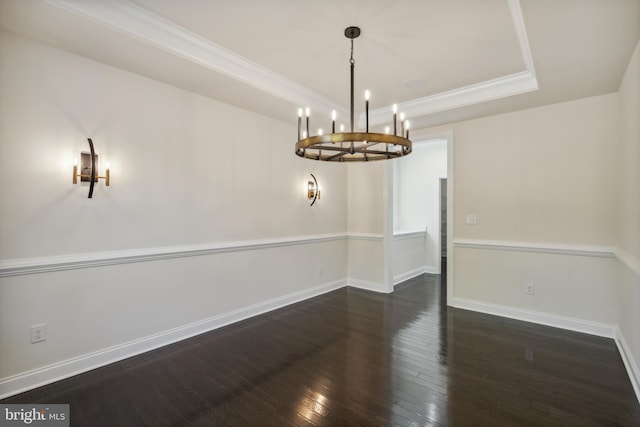 unfurnished dining area with crown molding, hardwood / wood-style floors, a raised ceiling, and baseboards