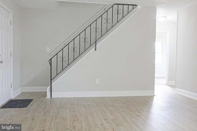 interior space with baseboards and wood finished floors