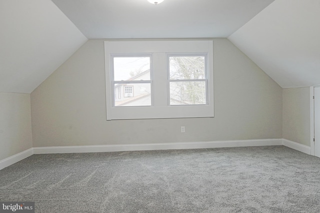 bonus room with lofted ceiling, carpet, and baseboards