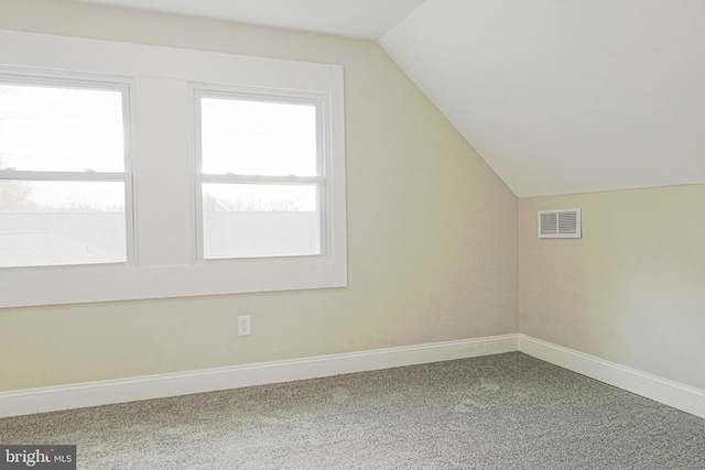 bonus room with a wealth of natural light, visible vents, and vaulted ceiling