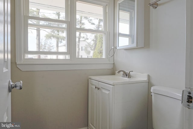 half bathroom with vanity and toilet