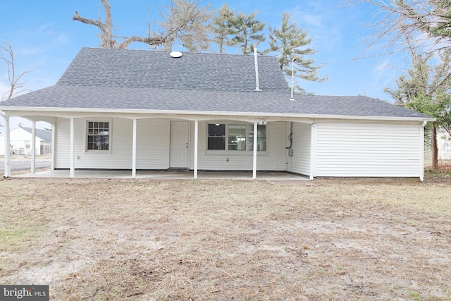 back of property with a shingled roof