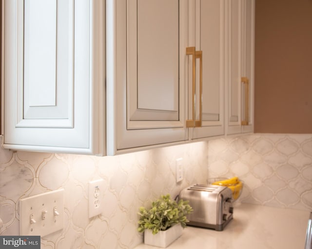 interior details featuring decorative backsplash and a toaster