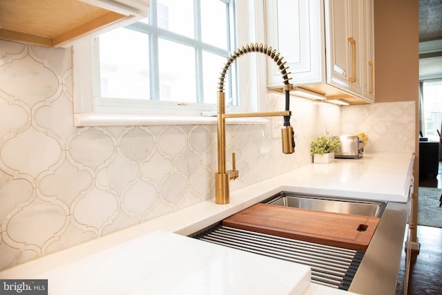 room details featuring light countertops and backsplash