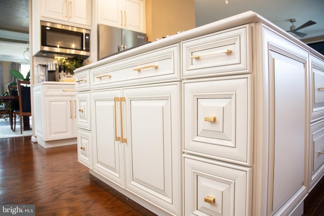 details featuring dark wood-style floors and stainless steel microwave