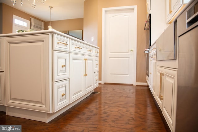 interior space with dark wood-type flooring and baseboards