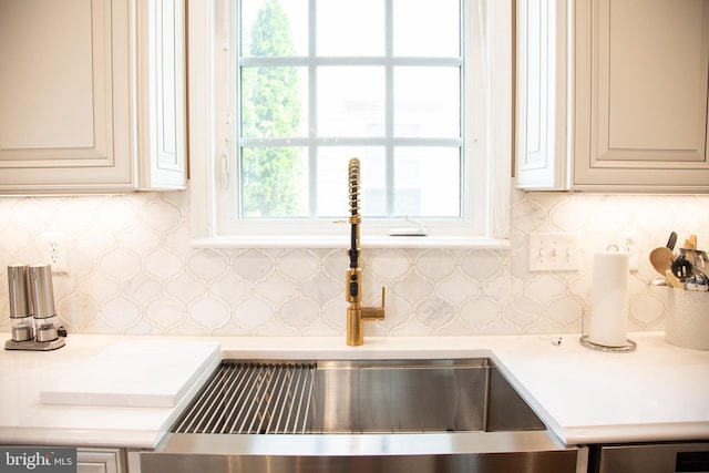 details with light countertops, a sink, and decorative backsplash