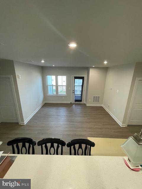 interior space with recessed lighting, visible vents, baseboards, and wood finished floors