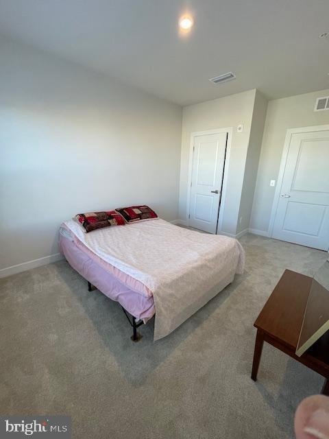 bedroom with carpet, visible vents, and baseboards