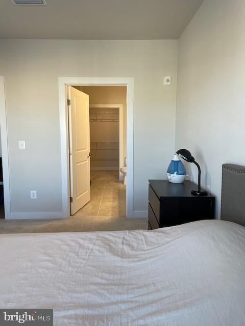 carpeted bedroom with visible vents and baseboards