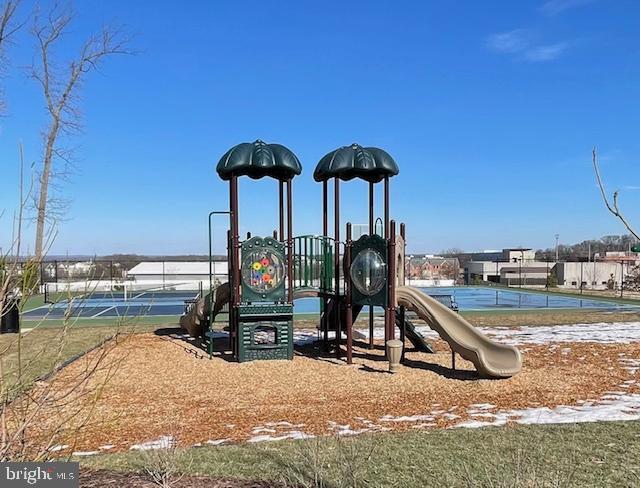 community play area with a tennis court