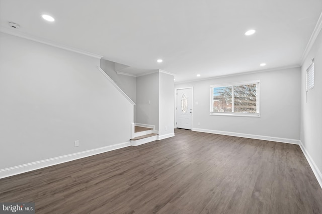 unfurnished living room featuring baseboards, stairway, dark wood-style flooring, crown molding, and recessed lighting