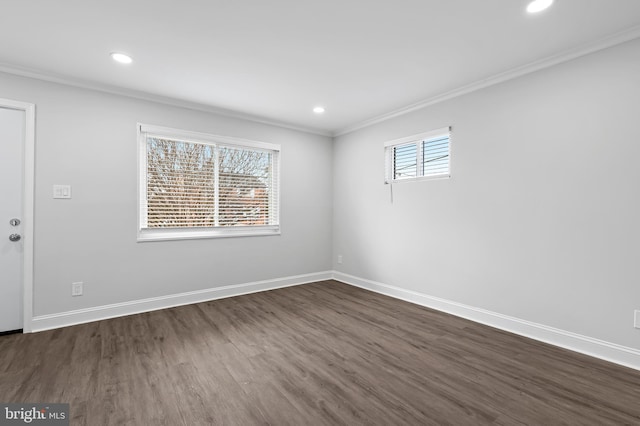 spare room with ornamental molding, recessed lighting, and baseboards