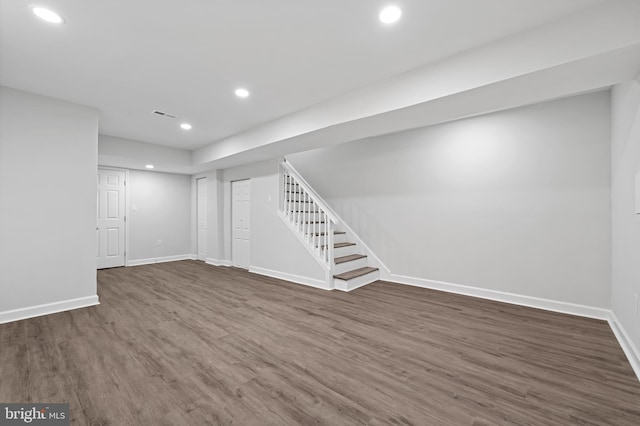 basement with recessed lighting, visible vents, wood finished floors, baseboards, and stairs