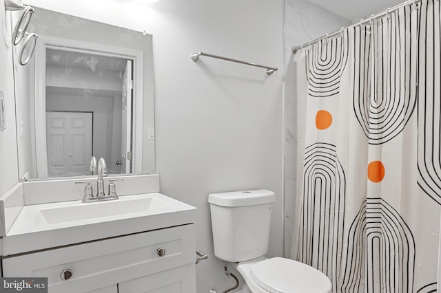 bathroom with vanity, toilet, and a shower with curtain