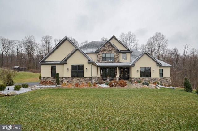 view of front of home featuring stone siding, a front lawn, and stucco siding