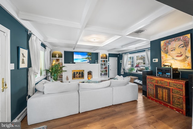 living room with visible vents, baseboard heating, a brick fireplace, wood finished floors, and coffered ceiling