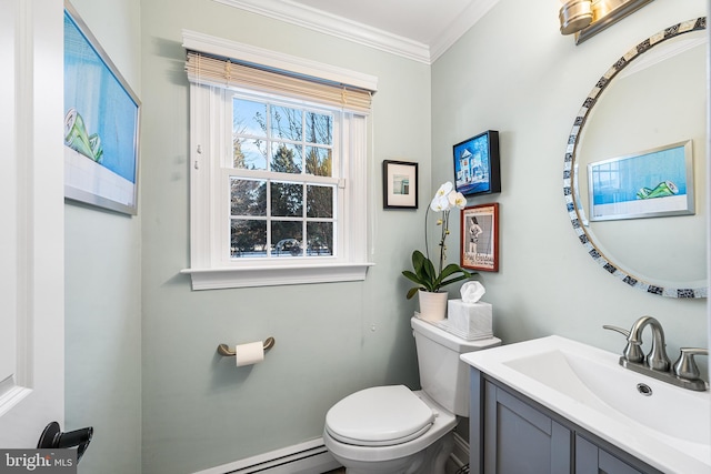 half bath with ornamental molding, vanity, and toilet