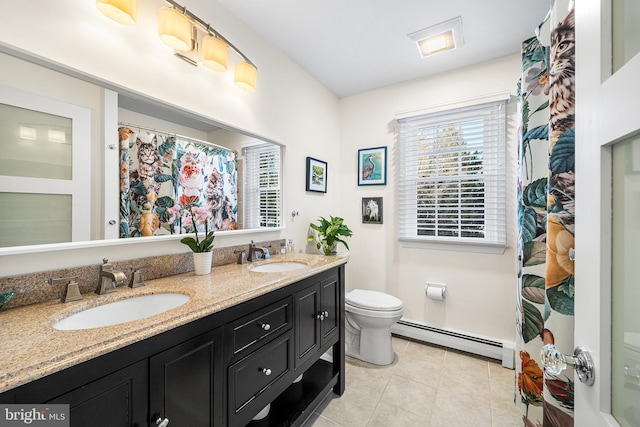 bathroom featuring toilet, a baseboard radiator, a sink, and tile patterned floors