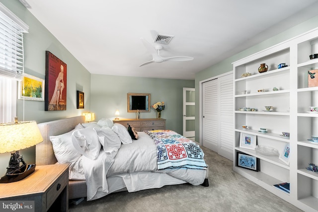 bedroom with carpet, visible vents, ceiling fan, and a closet