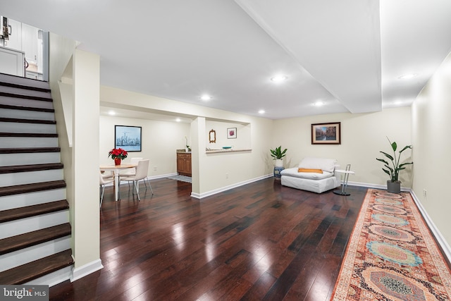 living room with stairway, baseboards, and hardwood / wood-style flooring