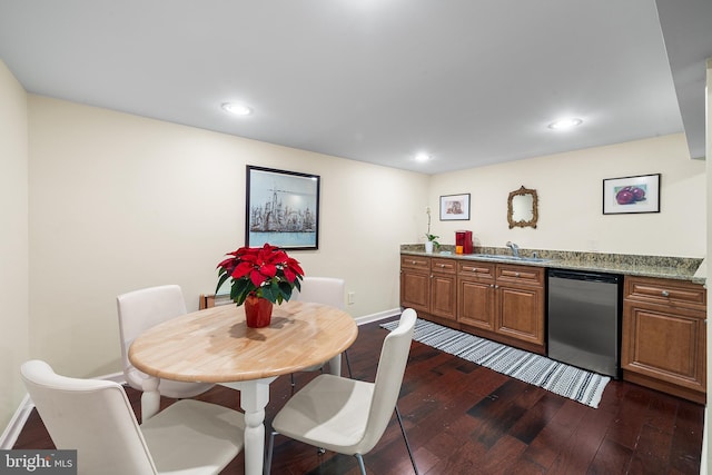 dining area featuring dark wood-style floors, wet bar, baseboards, and recessed lighting