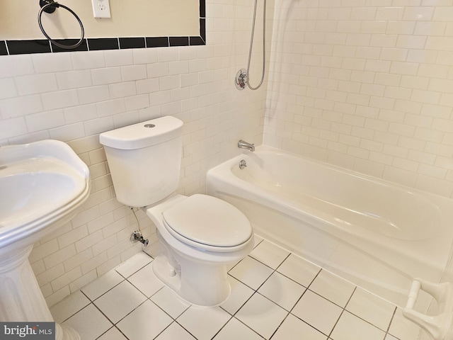 full bath featuring toilet, shower / bath combination, tile walls, and tile patterned floors