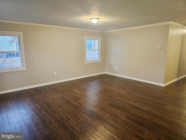 unfurnished room with dark wood finished floors, a healthy amount of sunlight, and crown molding