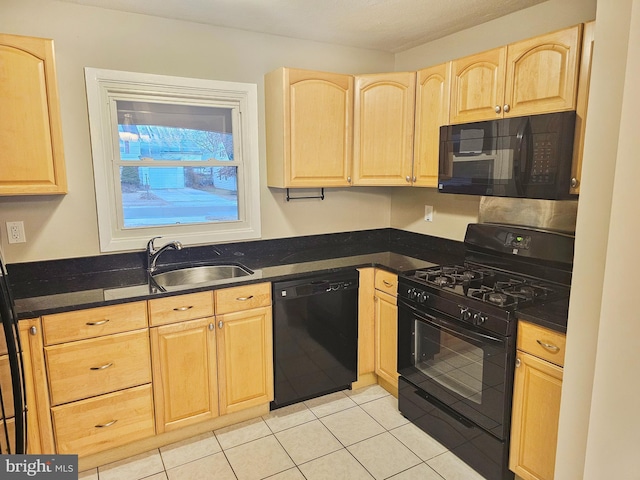 kitchen featuring light tile patterned flooring, a sink, black appliances, and light brown cabinetry