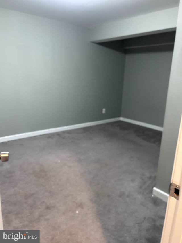 unfurnished bedroom with baseboards and carpet floors