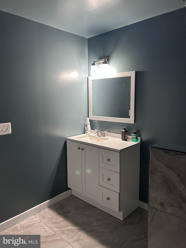 bathroom with baseboards and vanity