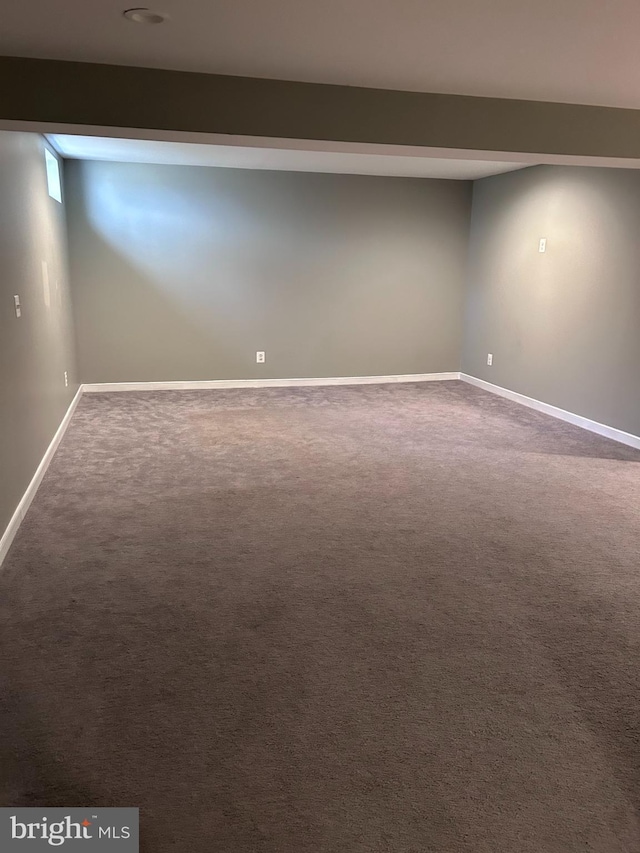 finished basement with baseboards and carpet flooring