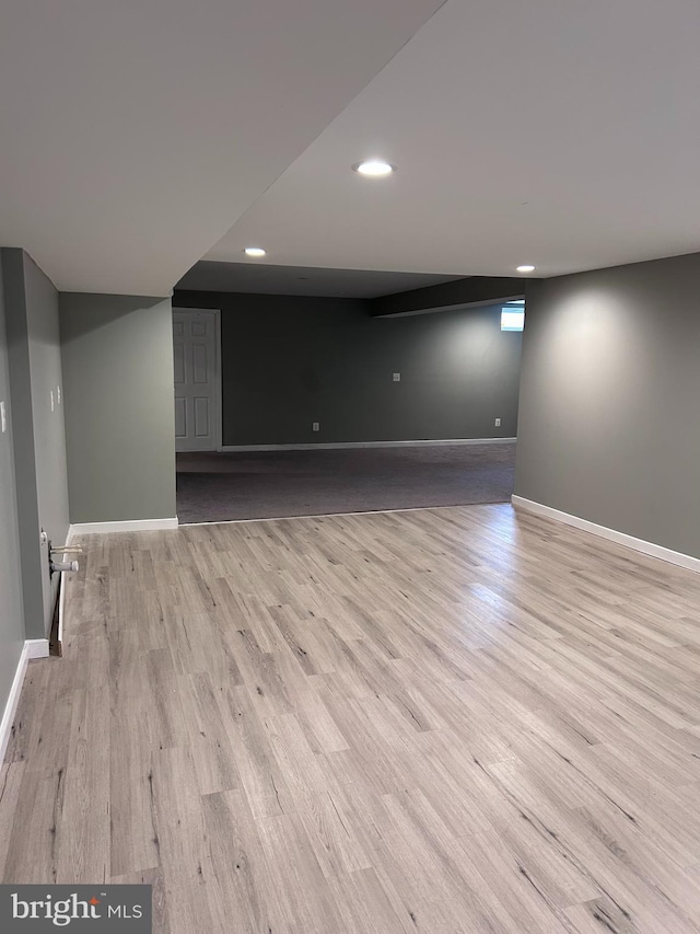 basement with light wood-style flooring, recessed lighting, and baseboards