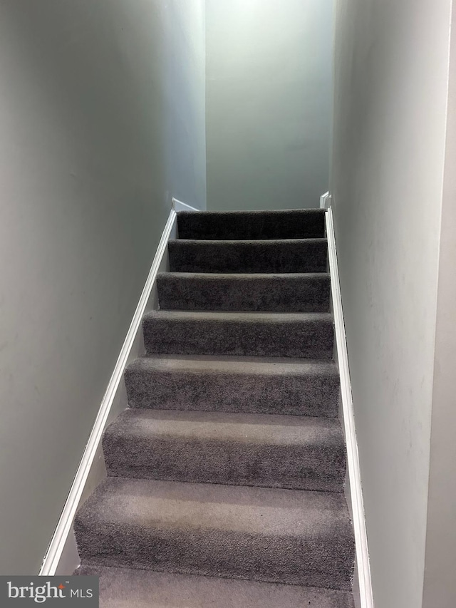 stairway featuring baseboards