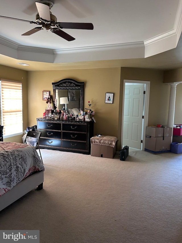 carpeted bedroom featuring decorative columns, a ceiling fan, and ornamental molding