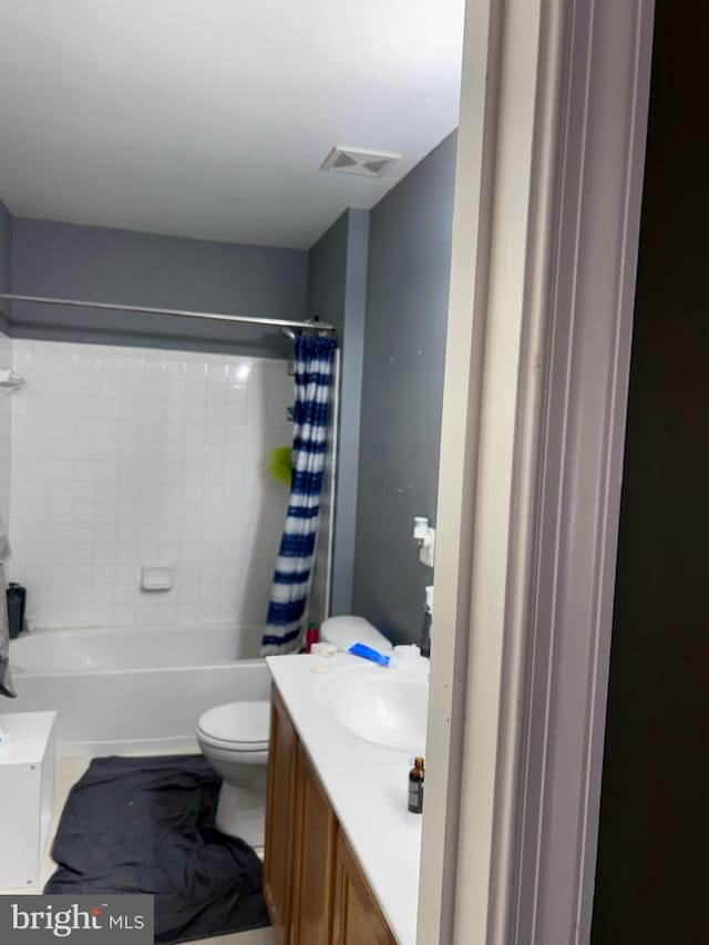 full bath featuring vanity, shower / tub combo, toilet, and visible vents