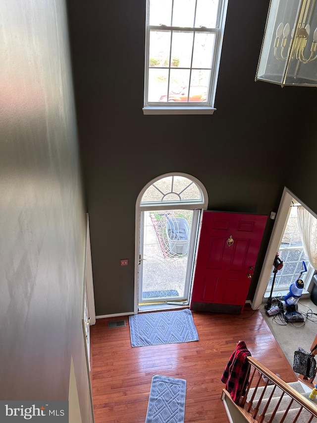 entrance foyer with a high ceiling and wood finished floors