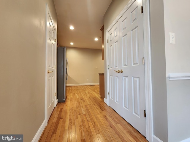 hall with light wood finished floors, recessed lighting, and baseboards