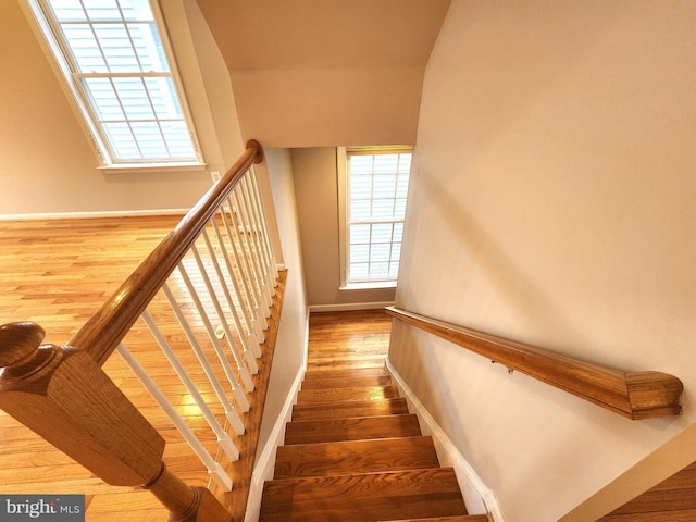 stairs featuring baseboards and wood finished floors