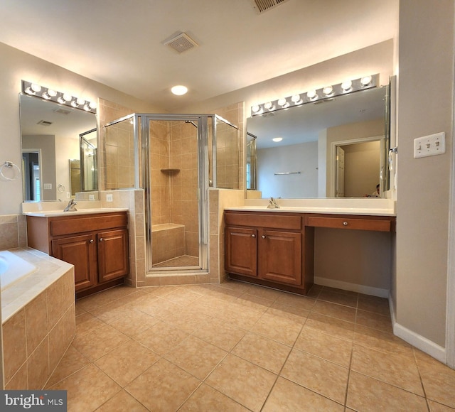 bathroom featuring tile patterned flooring, two vanities, a sink, a shower stall, and a bath