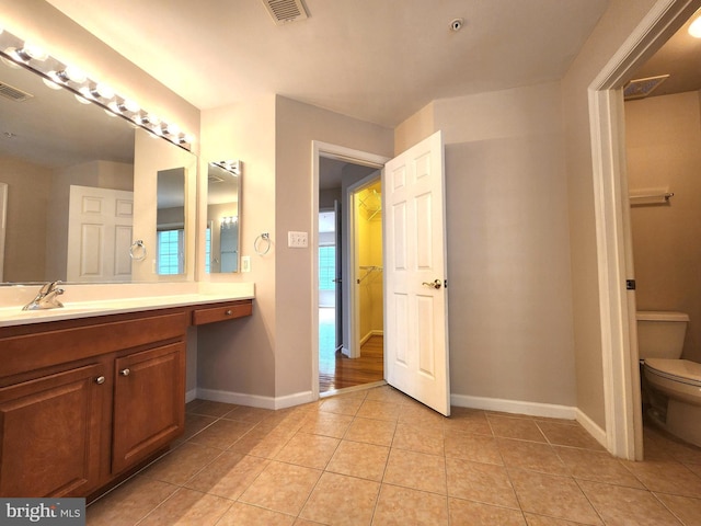 full bathroom with baseboards, visible vents, toilet, tile patterned floors, and vanity