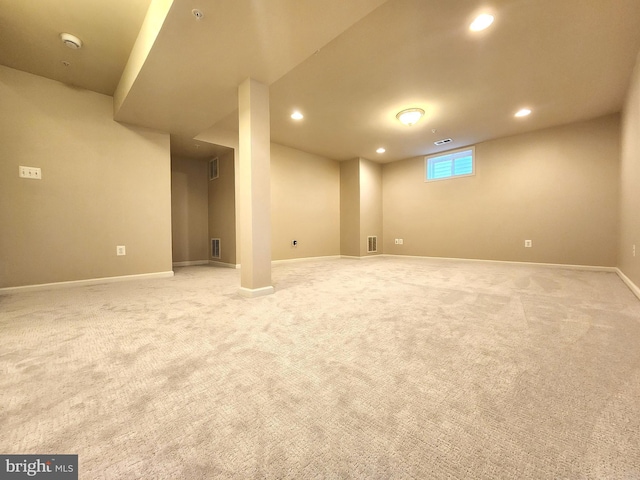 basement featuring recessed lighting, visible vents, baseboards, and light colored carpet