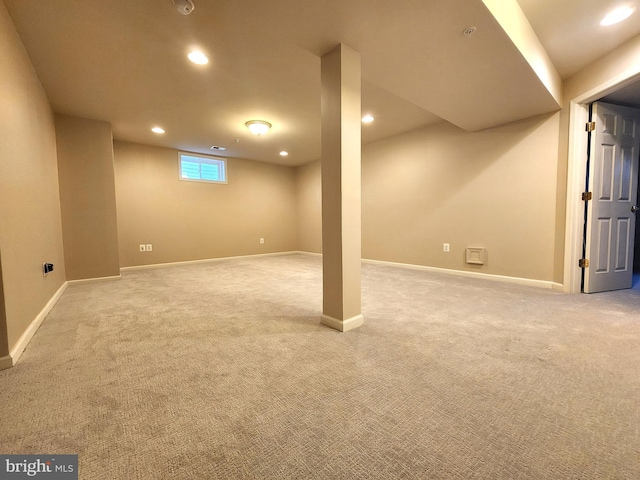 basement featuring baseboards, recessed lighting, and light colored carpet