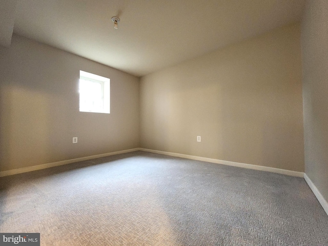 spare room with carpet and baseboards